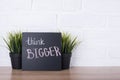 Text think bigger on blackboard Royalty Free Stock Photo