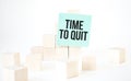 Text Time to quit writing in green card cube ladder. White background. Business concept