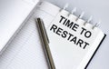 Text TIME TO RESTART on the short note texture background with pen Royalty Free Stock Photo