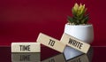 Text Time To Write Lettering Wooden Blocks on red and black background with cactus flower. Business Concept Royalty Free Stock Photo