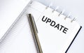 Text UPDATE on the short note texture background with pen Royalty Free Stock Photo