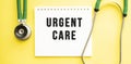 Text URGENT CARE on notebook with stethoscope on yellow background