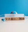 Text vaccine medical mask syringe and globe on background Royalty Free Stock Photo
