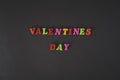 Text Valentines day by colorful letters on black background.
