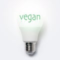 Text of Vegan on light bulb isolated on white background. Royalty Free Stock Photo