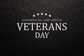 Text Veterans Day Honoring All Who Served on black textured background. American holiday typography poster.