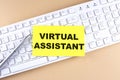 Text VIRTUAL ASSISTANT text on a sticky on keyboard, business concept Royalty Free Stock Photo