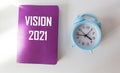 Text Vision 2021 is written on a crimson notepad that lies