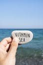 Text vitamin sea in a stone on the beach Royalty Free Stock Photo