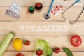 Text Vitamins, natural vitamins, vegetables, fruits and berries and tablets, pills and stethoscope