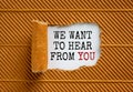 The text `we want to hear from you` appearing behind torn brown paper. Beautiful background. Business concept Royalty Free Stock Photo