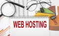 Text WEB HOSTING on white paper notebook on the diagram. Business concept