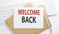 Text WELCOME BACK on the envelope on the keyboard Royalty Free Stock Photo