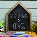 Text welcome to class in a house-shaped chalkboard Royalty Free Stock Photo