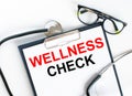 Text Wellness Check in the folder with the stethoscope and glasses Royalty Free Stock Photo