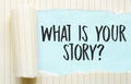 The text What is your story appearing behind torn white paper Royalty Free Stock Photo