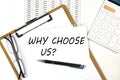 Text WHY CHOOSE US on the white paper on clipboard with chart and calculator Royalty Free Stock Photo