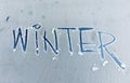 Text winter on a car glass.frost background Royalty Free Stock Photo