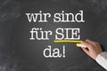 Text WIR SIND FUR SIE DA, German for we are here to assist you, written on chalkboard