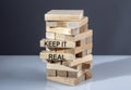 The text on the wooden blocks KEEP IT REAL