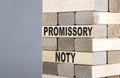 The text on the wooden blocks PROMISSORY NOTE