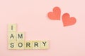 Text wooden blocks spelling the word I am sorry on pink background Royalty Free Stock Photo