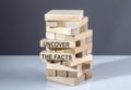 The text on wooden blocks UNCOVER THE FACTS