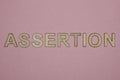 Text the word assertion from gray wooden small letters