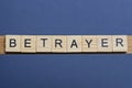 text the word betrayer from brown wooden small letters