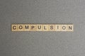 Text the word compulsion from gray wooden small letters