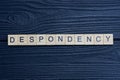 text the word despondency from brown wooden small letters