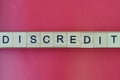 Text the word discredit from gray wooden small letters Royalty Free Stock Photo