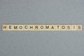 Text the word hemochromatosis from brown wooden small letters