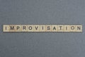 Text the word improvisation from brown wooden small letters