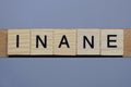 Text the word inane from brown wooden small letters