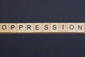 Text on word oppression from gray wooden letters