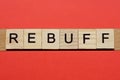 Text the word rebuff from gray wooden small letters