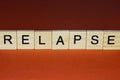 Text the word relapse from gray wooden small letters