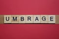 Text the word umbrage from gray wooden small letters