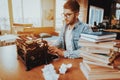 Text Writer Working on Typewriter Sits at Desk Royalty Free Stock Photo