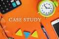 Text writing CASE STUDY, glasses, alarm clock, smartphone, calculator on orange background