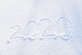 2020 text written on the background of fresh snow texture - winter holiday, Merry Christmas, New Year concept Sunny day Royalty Free Stock Photo