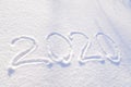 2020 text written on the background of fresh snow texture - winter holiday, Merry Christmas, New Year concept Sunny day Royalty Free Stock Photo