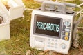 The text is written on the defibrillator monitor - PERICARDITIS