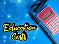 Text written Education Costs, pen, calculator and glasses. Education and finance concept