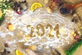 The 2021 text is written on flour among Christmas decorations and Christmas tree branches Royalty Free Stock Photo