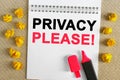 The text is written in the notebook - PRIVACY PLEASE. There is a marker on the notebook, next to it is crumpled yellow paper Royalty Free Stock Photo