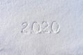 Text 2020 written on white fresh snow in sunny winter day. Merry Christmas and Happy New Year. Winter holiday concept Royalty Free Stock Photo