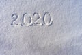 Text 2020 written on white fresh snow in sunny winter day. Merry Christmas and Happy New Year. Winter holiday concept Royalty Free Stock Photo