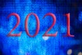 Text with the year number 2021 with a background of bright blue lights out of focus with Bokeh effect Royalty Free Stock Photo